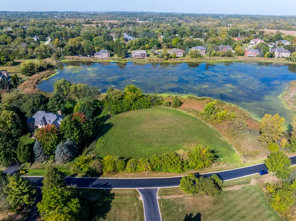 an aerial view of a house with a yard