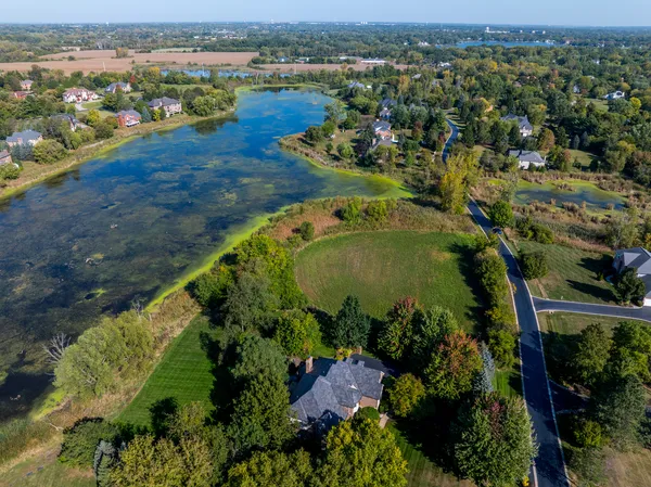 an aerial view of a houses with a lake view