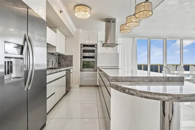 a kitchen with stainless steel appliances granite countertop a sink and a refrigerator