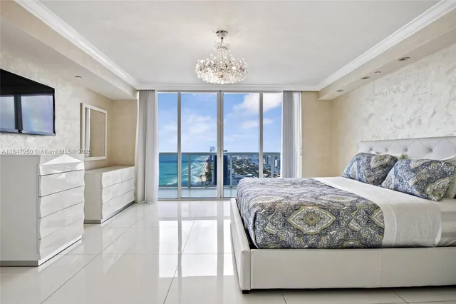 a living room with a bed furniture and a large window