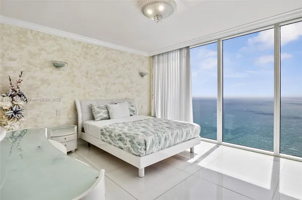 a bedroom with a bed and a mirror