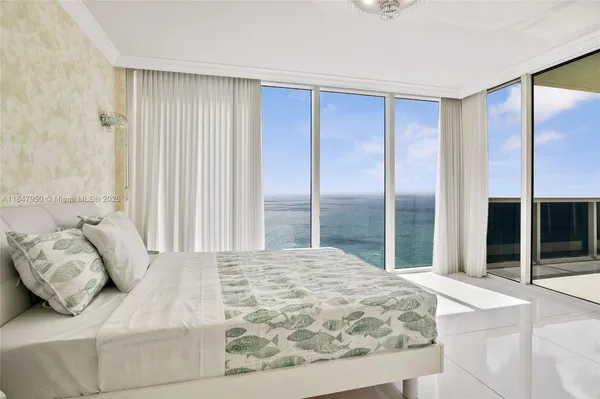 a bedroom with a large bed and a large window