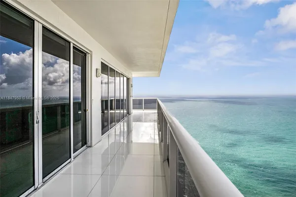 a balcony with view of an outdoor space