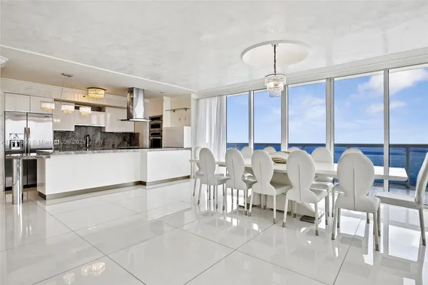 a large kitchen with a table and chairs