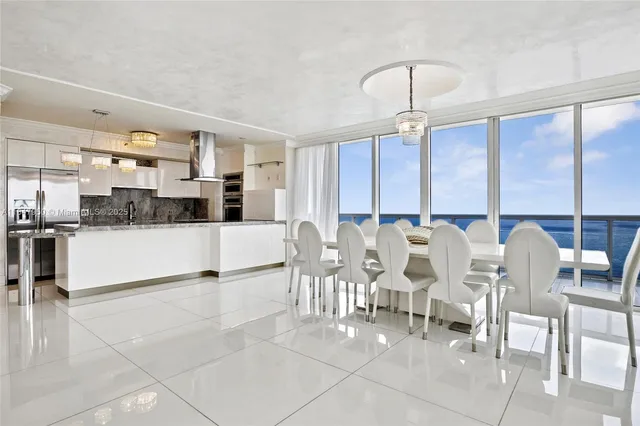 a large kitchen with a table and chairs