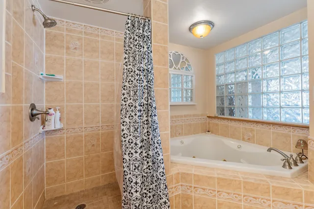 a bathroom with bathtub and window