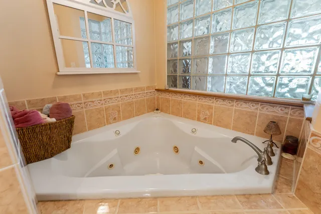 a bedroom with a bed dresser and a window