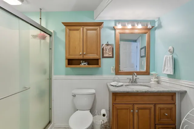 a bedroom with a bed a dresser and flat screen tv