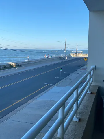 a view of a room with an empty space and a ocean view
