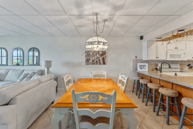 a dining room with a table chairs and a chandelier