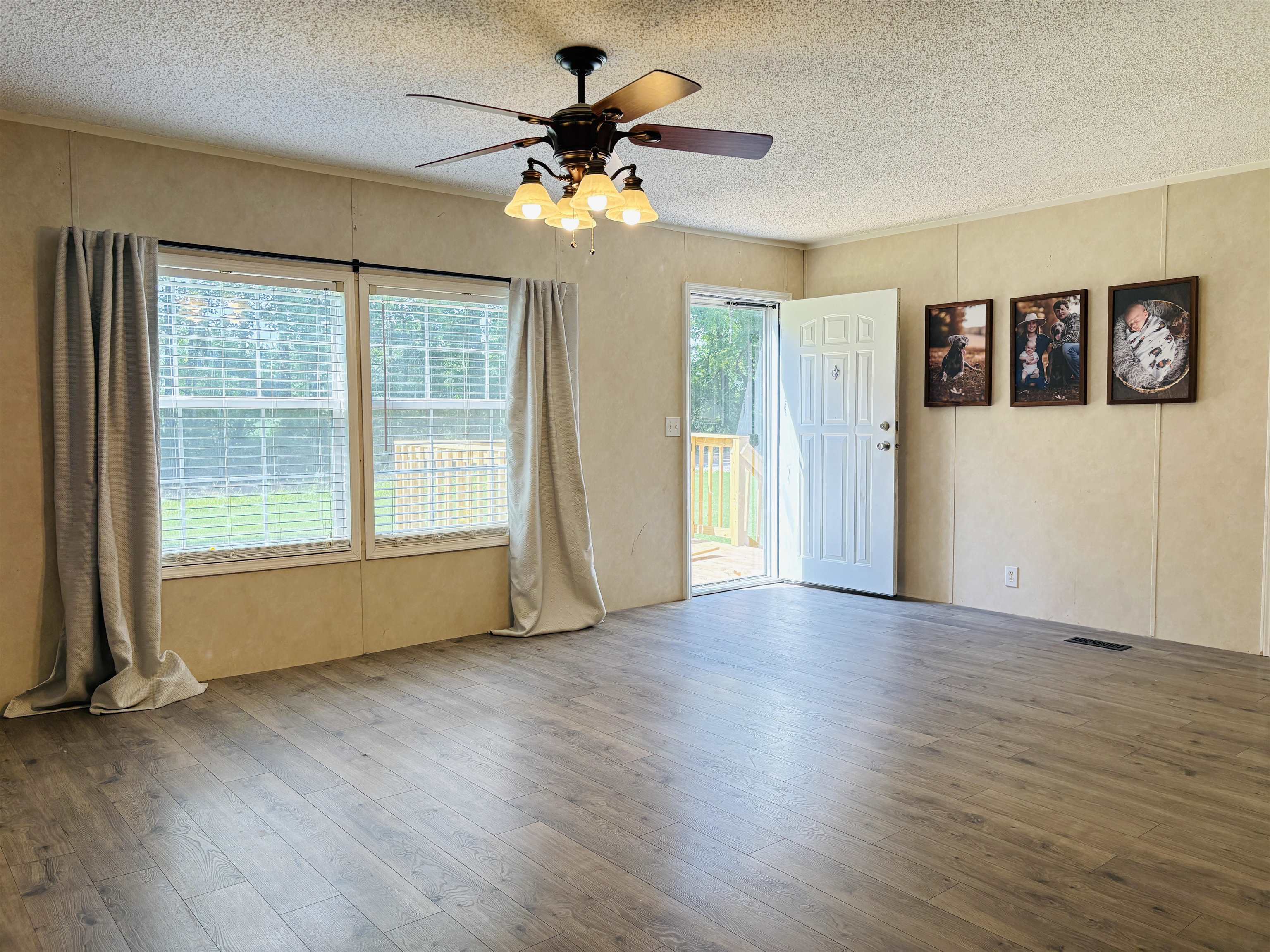 476 Pickens Store Road Mason, TN 38049 - Photo 4 of 18 a view of an empty room with a window and wooden floor