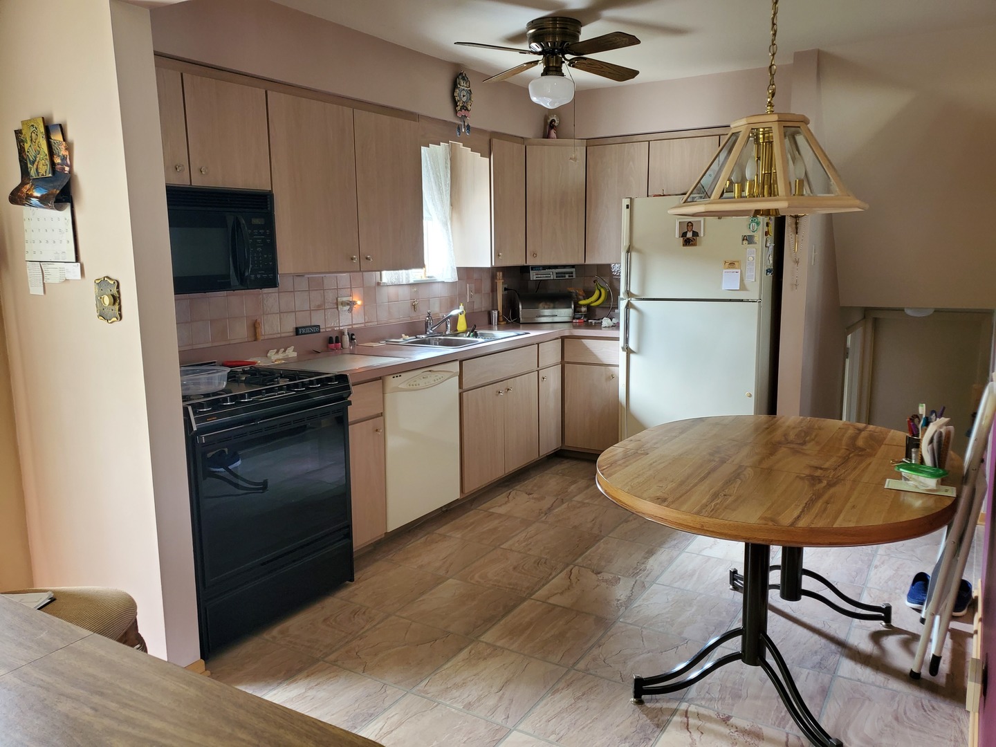 6139 107th Street Chicago Ridge, IL 60415 - Photo 2 of 16 a kitchen with kitchen island a stove a chandelier and a refrigerator