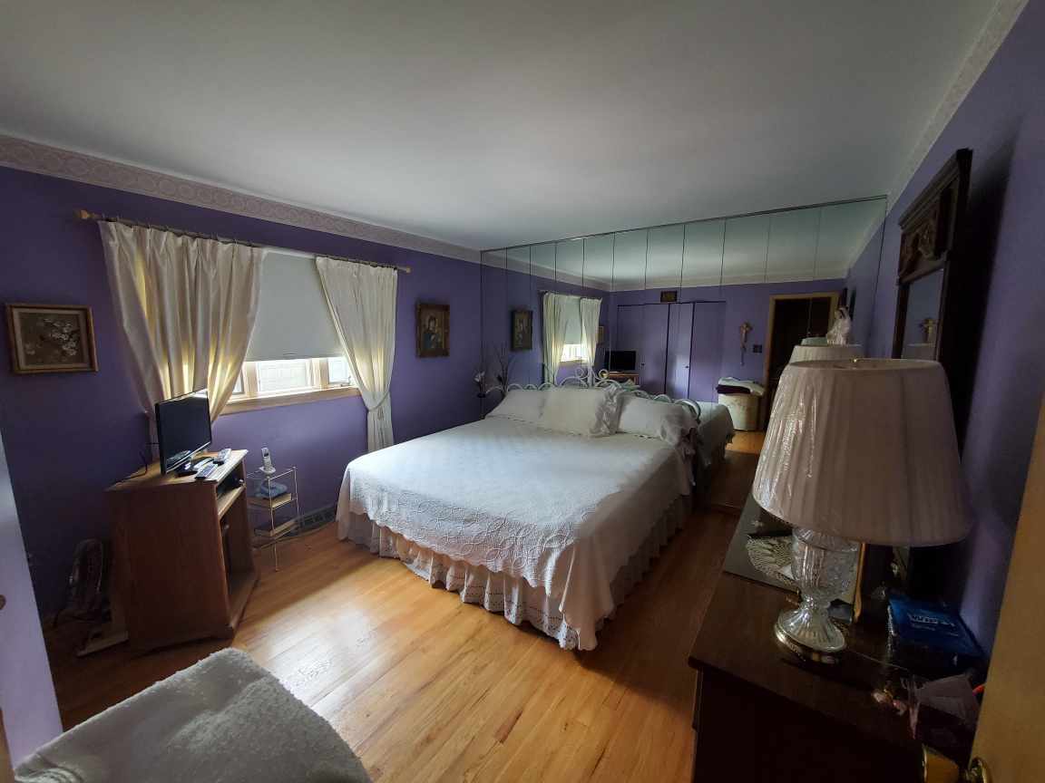 6139 107th Street Chicago Ridge, IL 60415 - Photo 11 of 16 a spacious bedroom with a bed and wooden floor