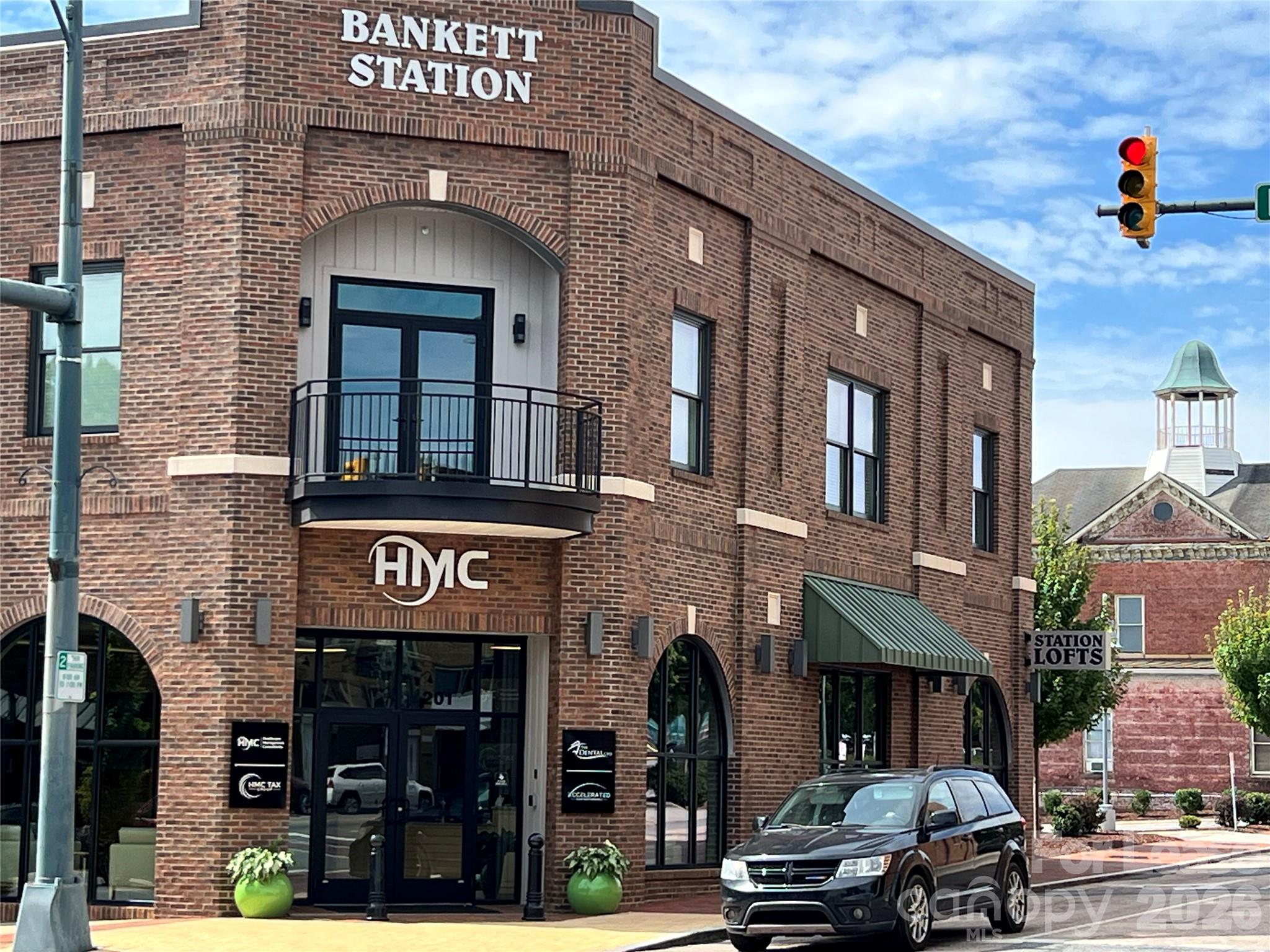 201 East Innes Street, Unit 202 Salisbury, NC 28144 - Photo 2 of 16 a front view of a building with parking space and a street light pole
