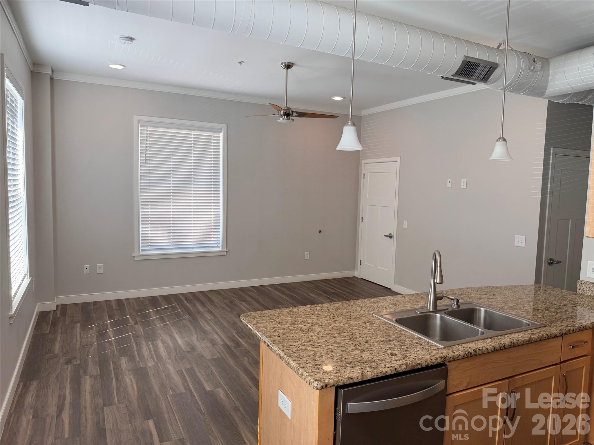 201 East Innes Street, Unit 202 Salisbury, NC 28144 - Photo 7 of 16 a bathroom with a granite countertop sink and a mirror