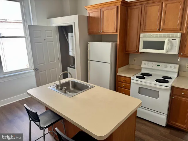 a kitchen with a stove a sink and a refrigerator