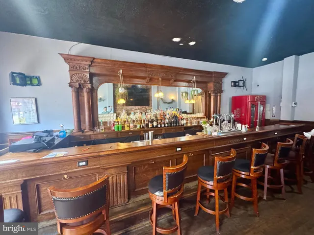 a kitchen with a table chairs sink and cabinets