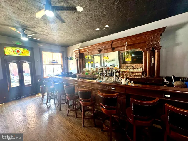 a kitchen with a table chairs and wooden floor