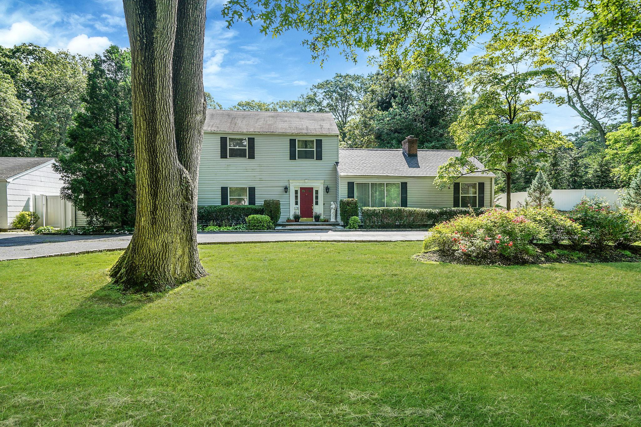 178 Beverly Road South Huntington, NY 11746 - Photo 1 of 1 Colonial-style house with a chimney