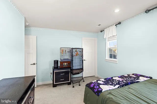 a bedroom with a bed and a bookshelf