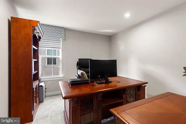 a view of a workspace with furniture