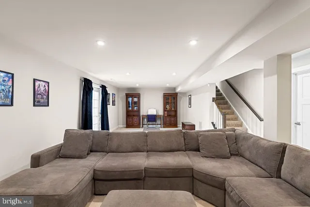 a bathroom with a toilet sink vanity and mirror