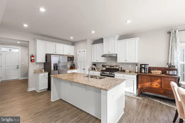 a kitchen with refrigerator and stove