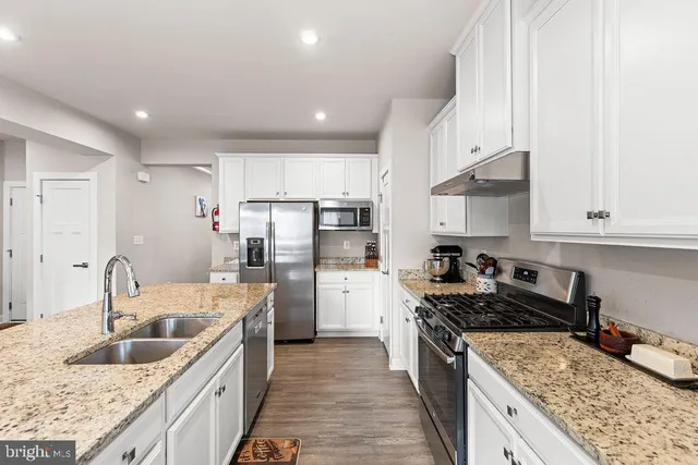 a kitchen with a sink stove and refrigerator