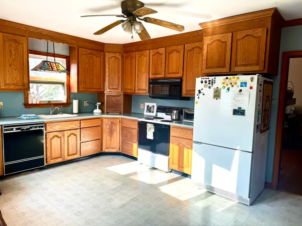 a kitchen with stainless steel appliances granite countertop a refrigerator a stove a sink dishwasher and a microwave