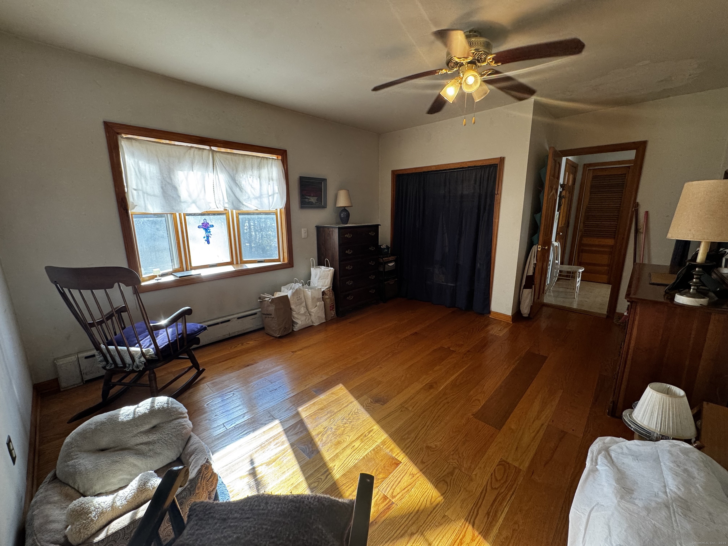 58 Daniels Farm Road Trumbull, CT 06611 - Photo 12 of 40 a bedroom with a bed and wooden floor