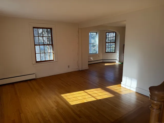 wooden floor in an empty room with a window