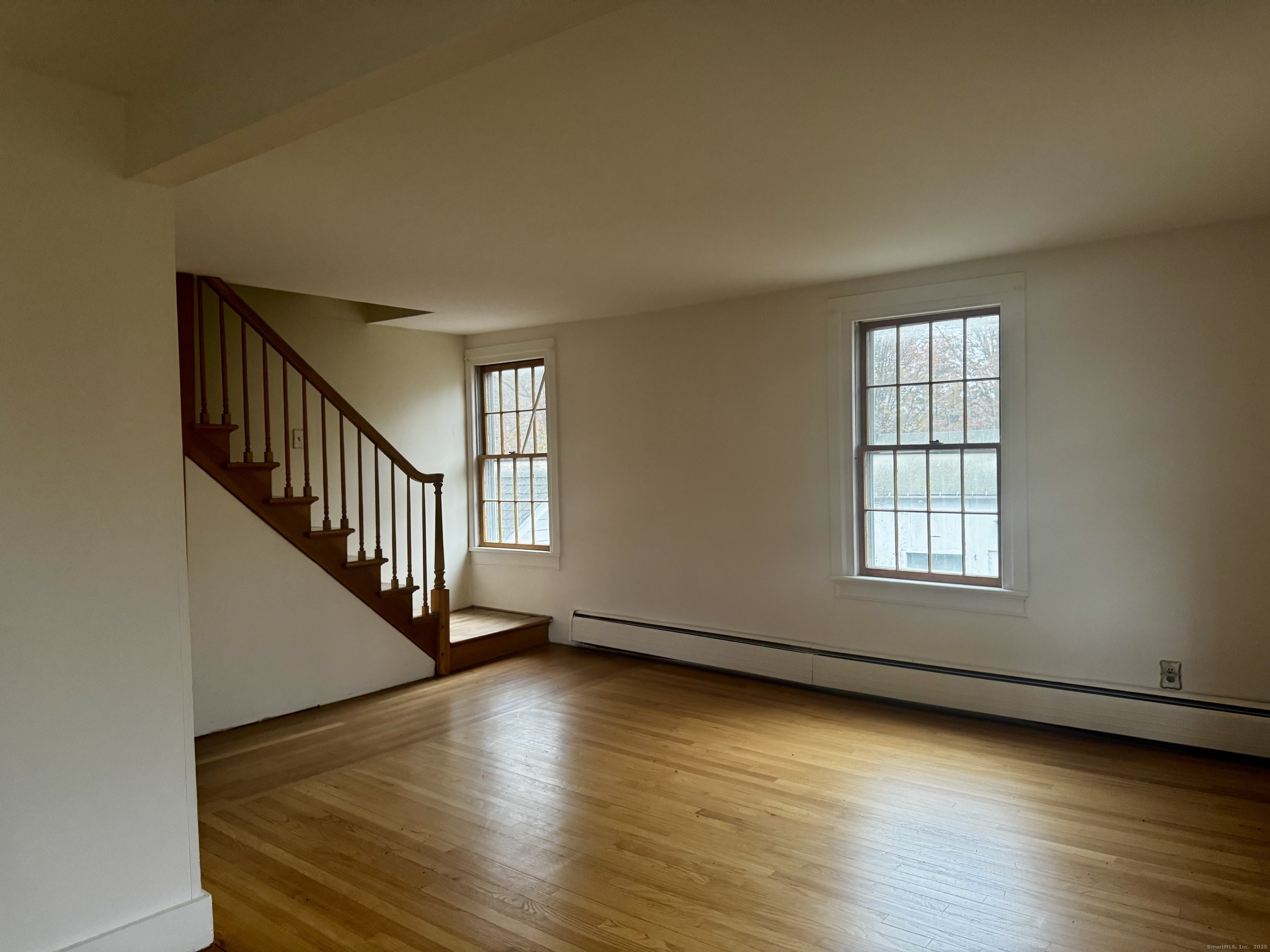 58 Daniels Farm Road Trumbull, CT 06611 - Photo 18 of 40 a view of an empty room with wooden floor and a window