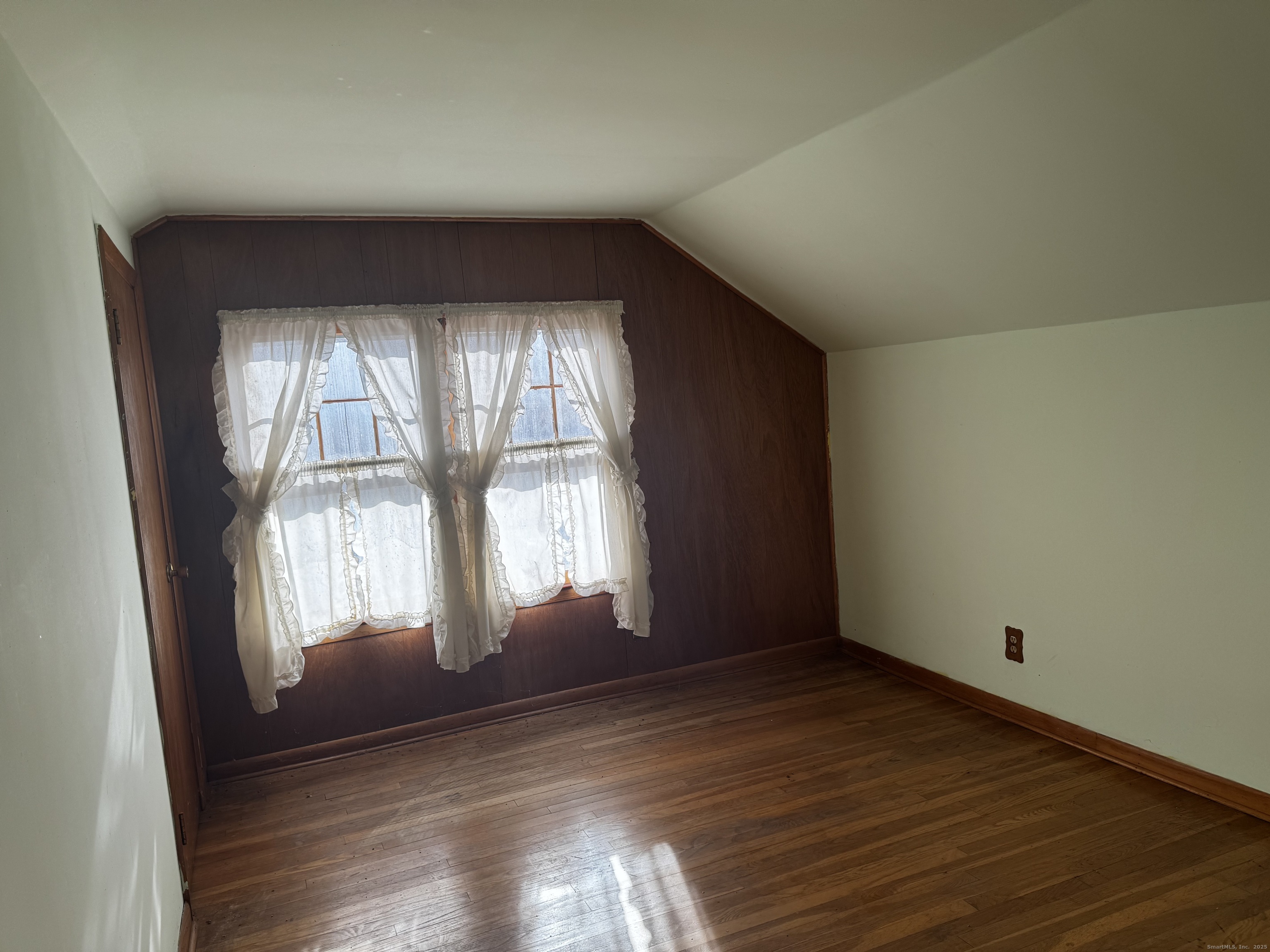 58 Daniels Farm Road Trumbull, CT 06611 - Photo 20 of 40 an empty room with wooden floor and windows