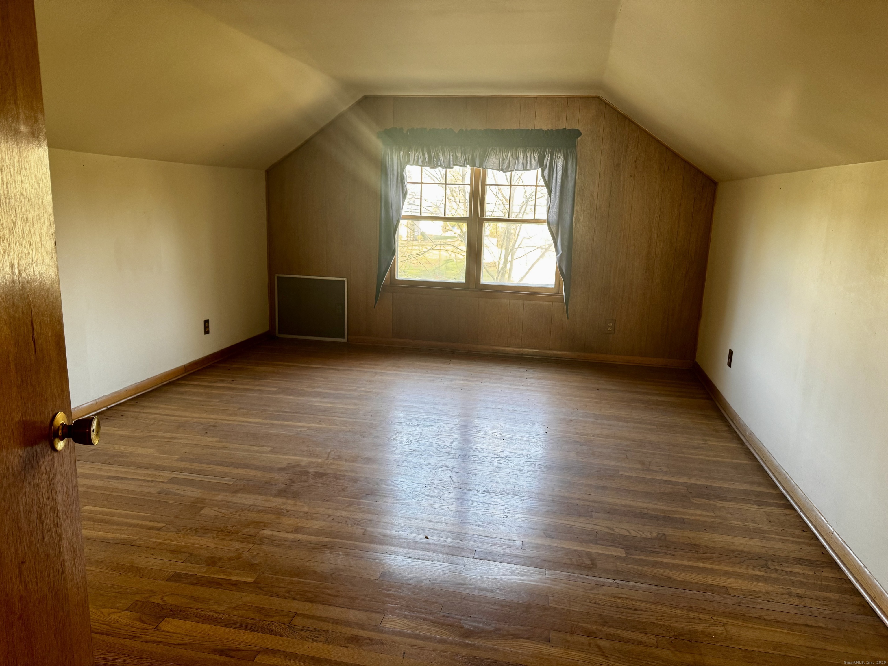 58 Daniels Farm Road Trumbull, CT 06611 - Photo 21 of 40 a view of an empty room with wooden floor and a window