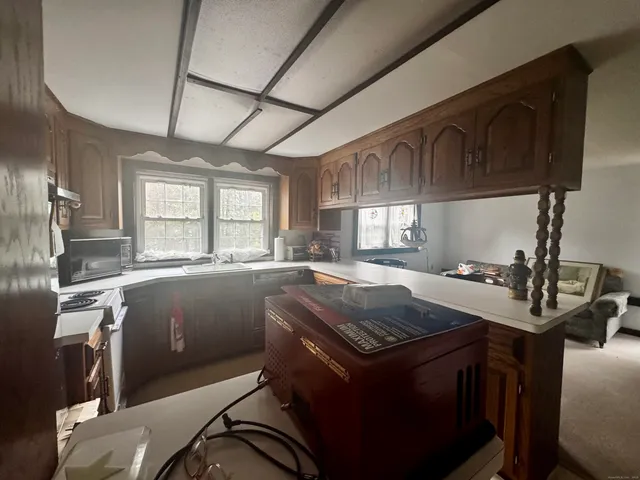 a kitchen with a sink a stove and cabinets