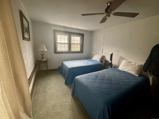 a bedroom with two beds and a window