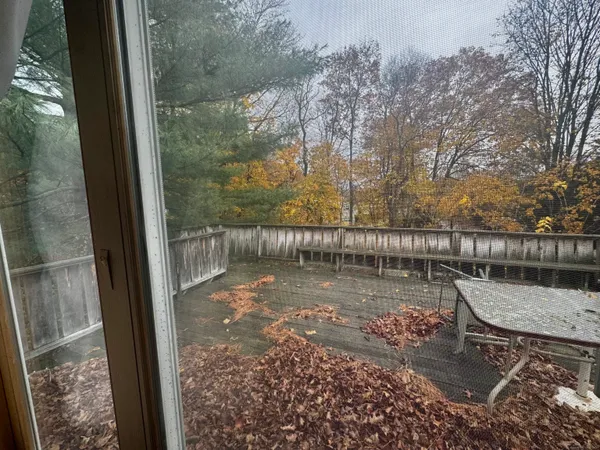a view of a lake with a bench next to a yard
