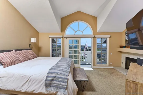 a bedroom with a large bed and a tv