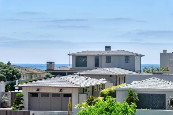 a view of a house with roof deck and seating space