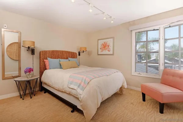 a bedroom with bed and wooden floor