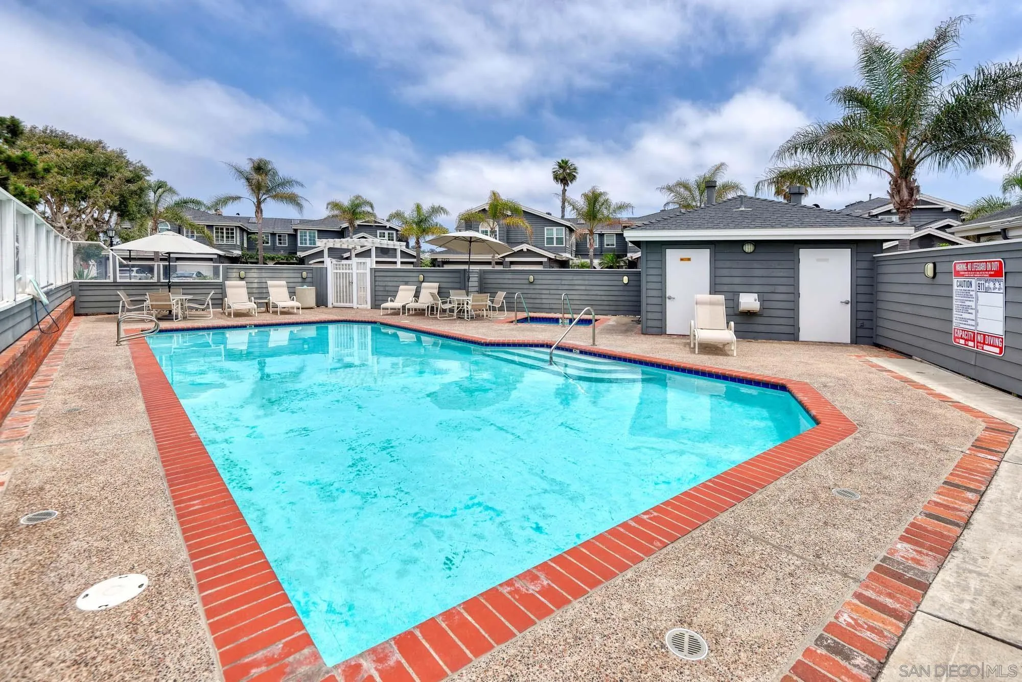 2921 Sandy Pointe, Unit 3 Del Mar, CA 92014 - Photo 22 of 31 a view of a swimming pool with a lounge chairs