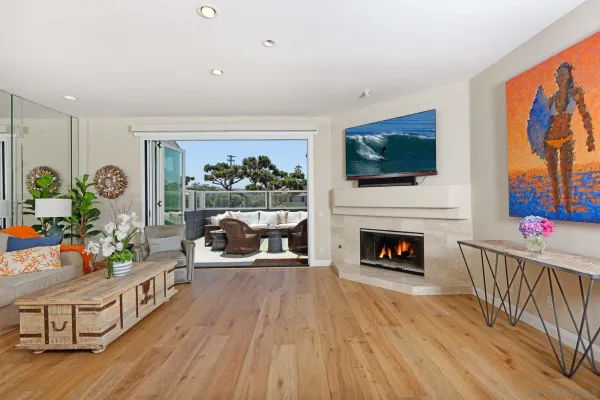 a living room with furniture a flat screen tv and a fireplace