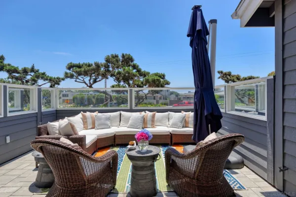 a view of balcony with couch and chairs