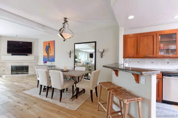 a view of a dining room with furniture and a flat screen tv