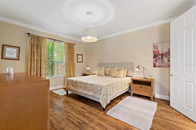 a bedroom with a large bed and a chandelier