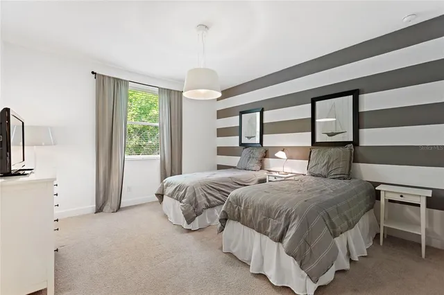 a bedroom with a bed and a large window