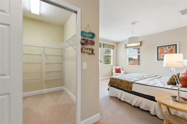 a spacious bedroom with a bed and a cabinets