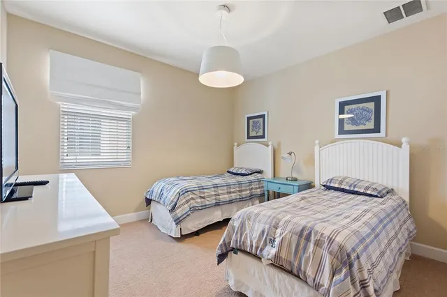 a bedroom with two beds and a window