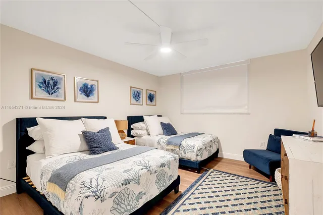 a bedroom with two beds and a couch