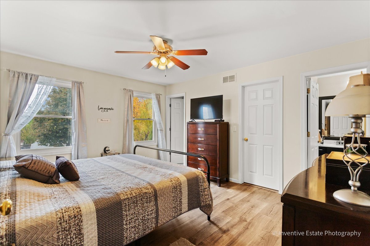 1818 Lobelia Lane Plainfield, IL 60586 - Photo 11 of 19 a bedroom with a bed and a flat screen tv